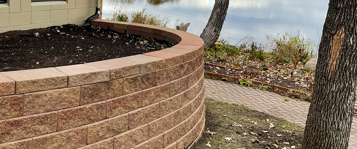Hardscapes-3 a a retaining wall project for a flower bed that is completed at a lake side home