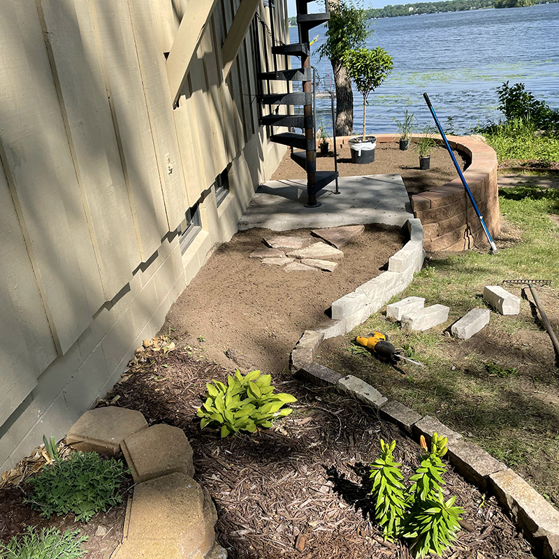 Lawn-Maintenance-6 Adding a rock border to a flower bed at a lake front home