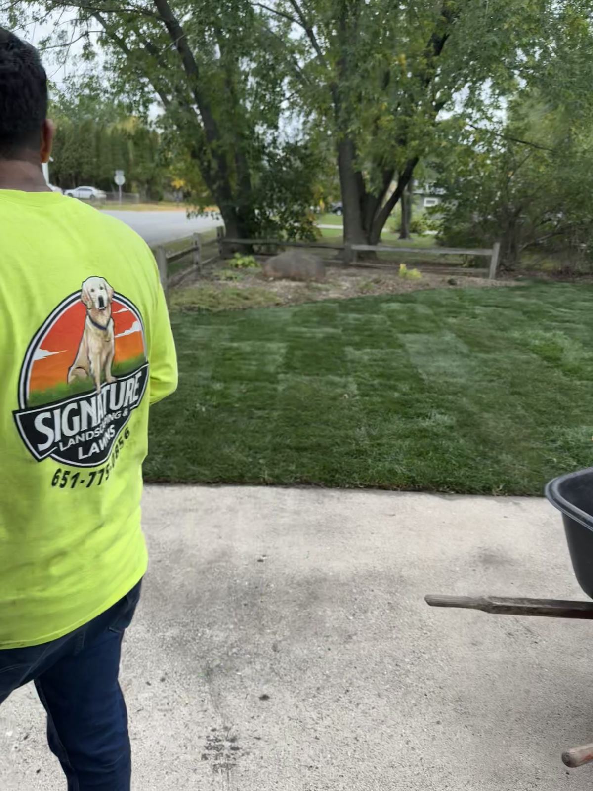 Signature Lawns crew member checking a finished sod installation