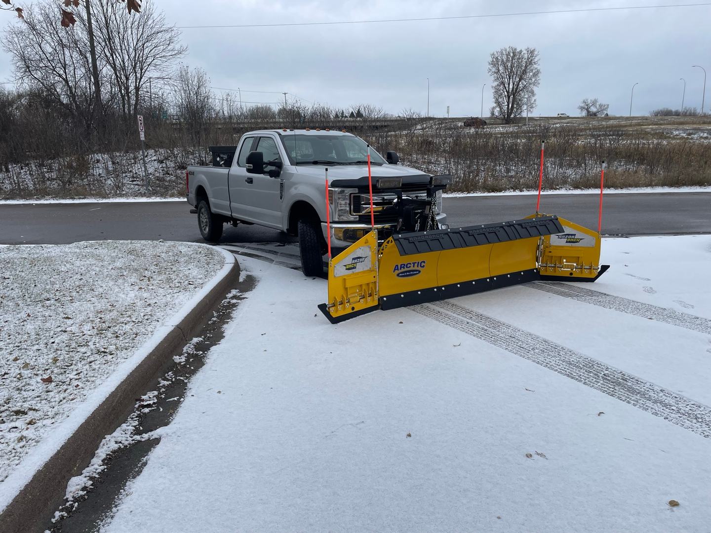 Signature Lawns plow truck with an Arctic pusher blade ready for snow removal