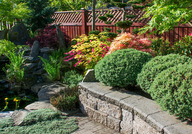 Beautiful-Hardscape-Designs Beautiful rock retaining wall and pond made by Signature Lawns