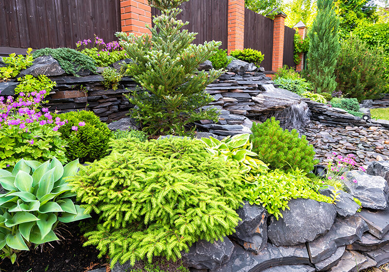 Beautiful-Landscaping Stacked stone flower bed with pond and waterfall