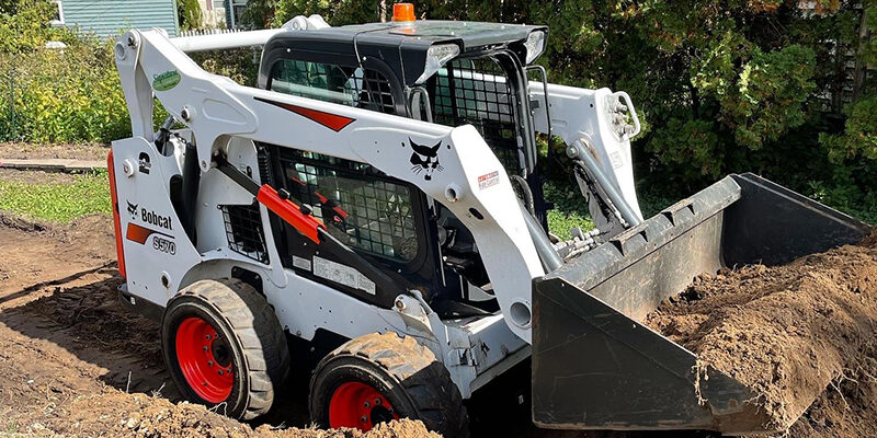 Light-Excavating-Signature-Lawns White Bobcat diging a new driveway
