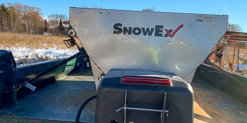 Snow removal services with Signature Lawns salting truck